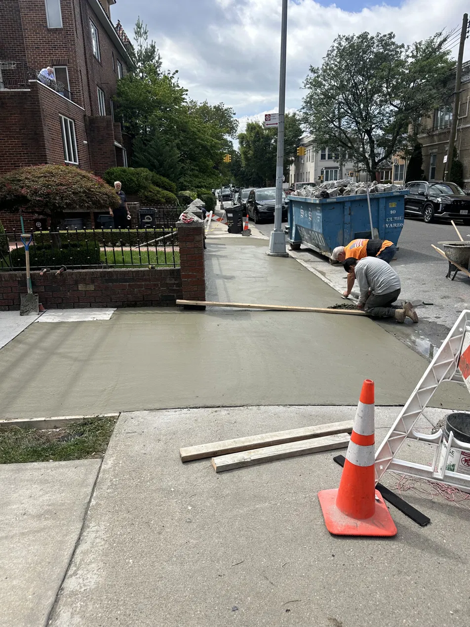 Concrete sidewalk replacement in progress on a residential street