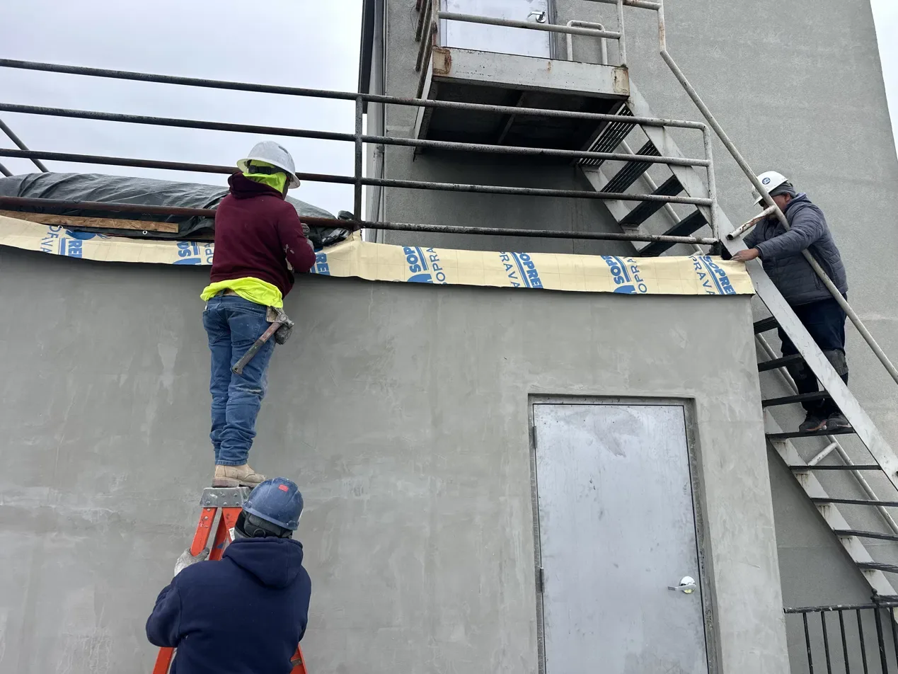 Best Valana crew finishing stucco on a rooftop bulkhead in New York City